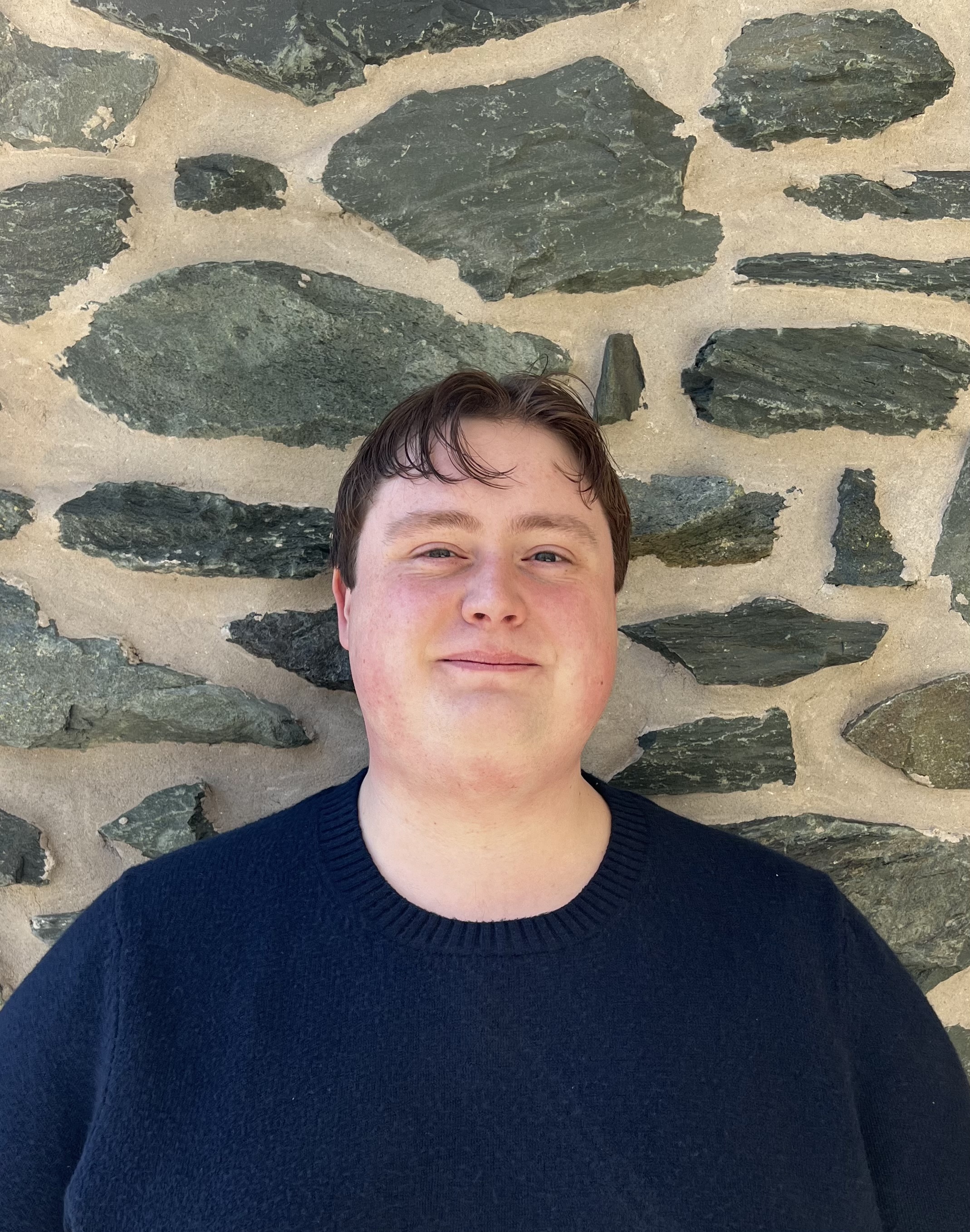 Person standing in front of brick wall