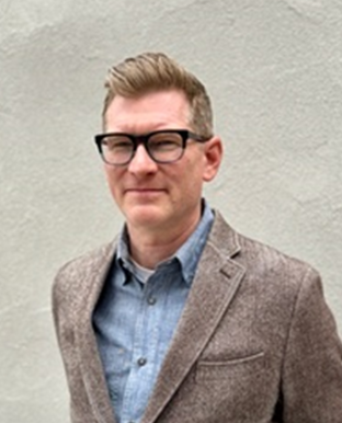 Person in suit smiling