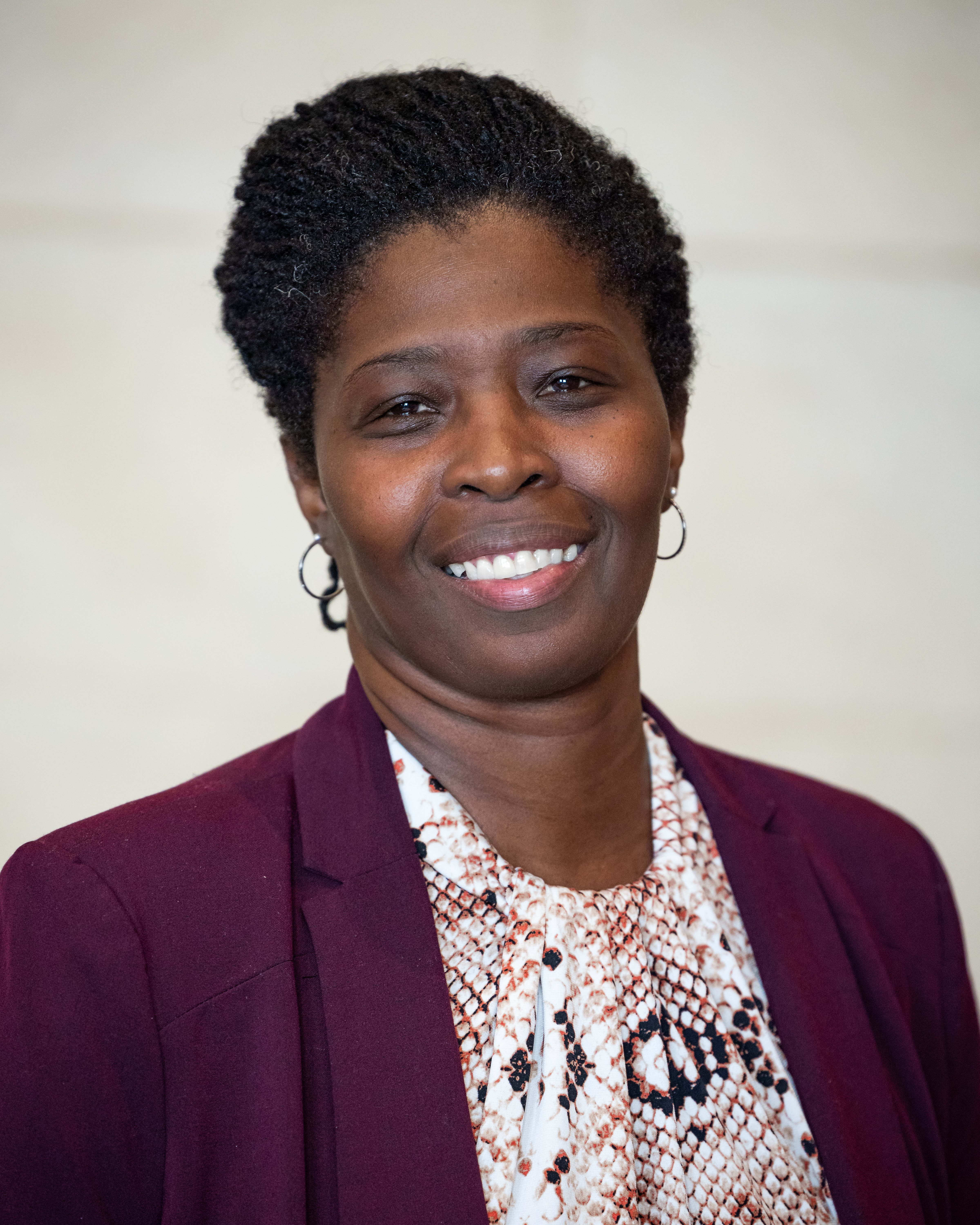 headshot of trisha smiling outside