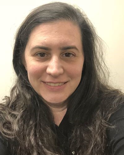 headshot of heather smiling with beige background