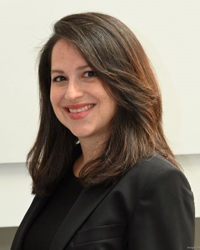 image of elana facing toward the left smiling with beige background